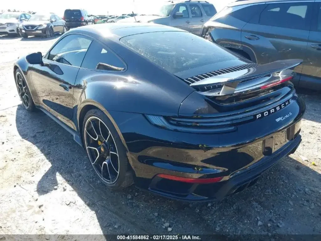 Tył i prawa strona Porsche 911 Turbo S – widoczny aktywny spojler, dwie pary końcówek wydechu, lakier czarny.