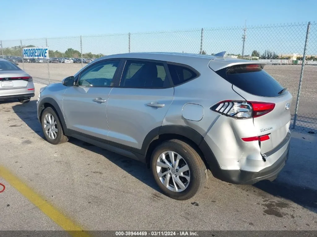 Srebrny Hyundai Tucson – tył i prawa strona, widoczna wgniotka zderzaka/ćwiartki.