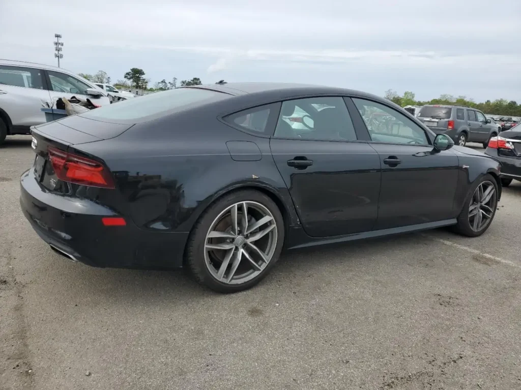 Czarny Audi A7 Sportback - widok z boku i tyłu na parkingu.